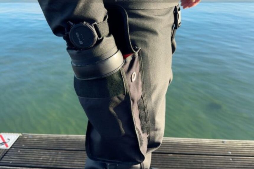 Drysuit Thigh Pocket Detail Thigh pocket and strapped-on canister on a drysuit leg, photographed on a jetty during DIVEIN testing