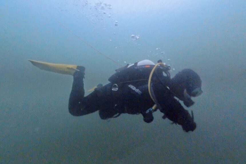 BARE Sentry Tech Buoyancy Underwater Our tester hovering in murky cold water in the BARE Sentry Tech neoprene drysuit