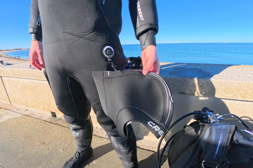 Hood clipped to the thigh of the Cressi Desert drysuit as our tester gears up by the water