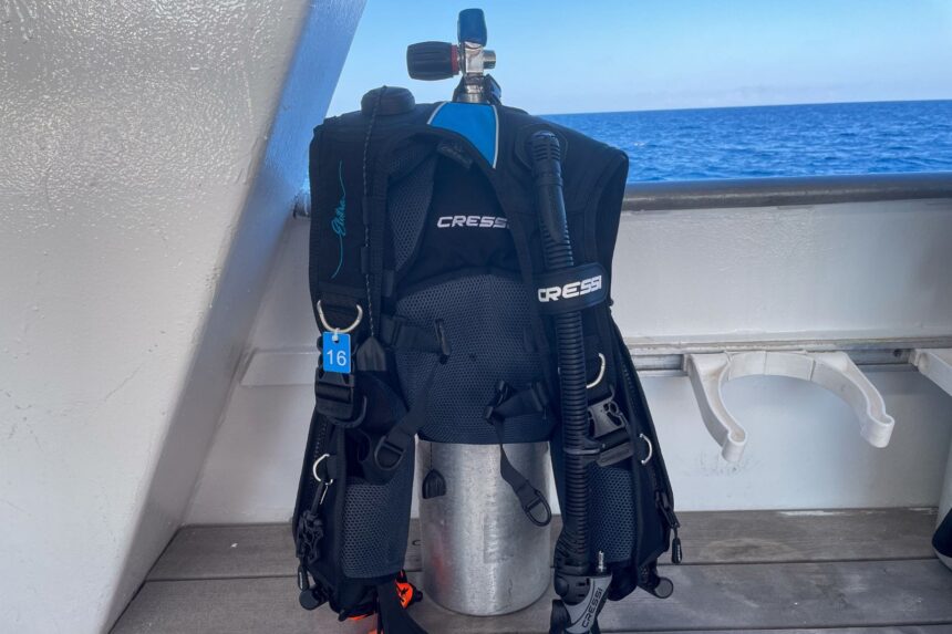 Cressi Elettra BCD rigged to a cylinder on a dive boat deck, showing the front D-rings