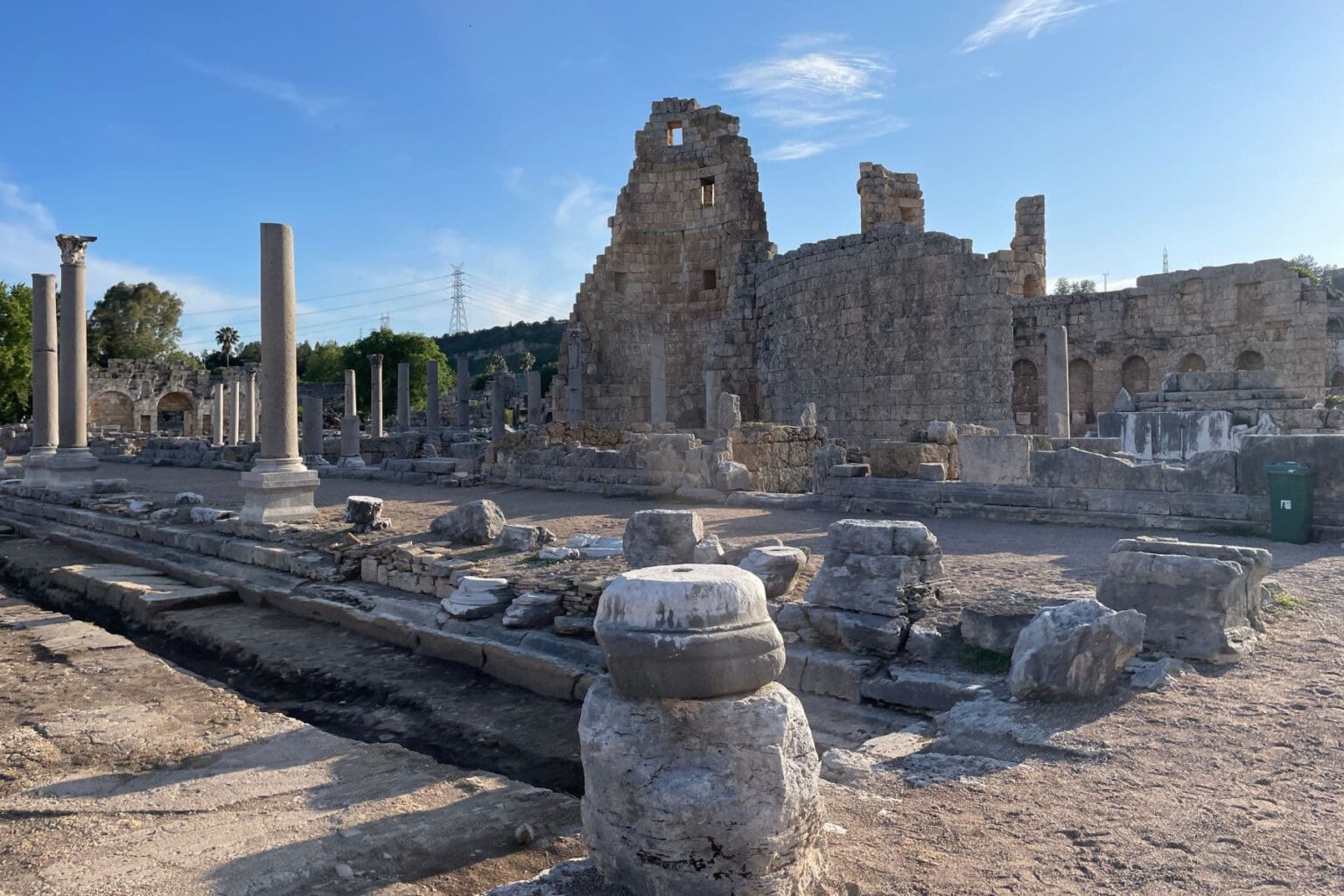 Ancient stone columns and ruined walls at Perge in Turkey under a clear blue sky