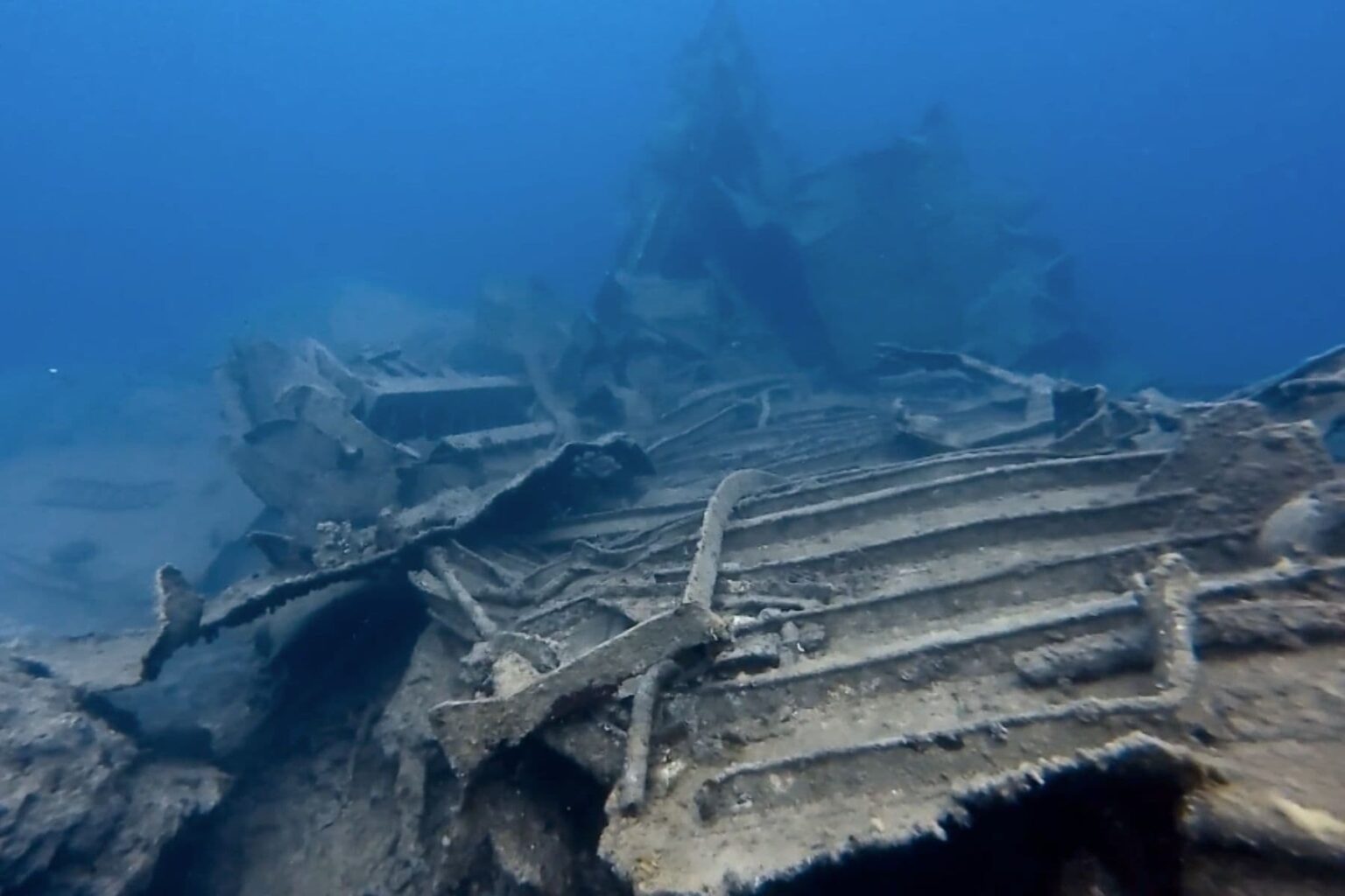 Twisted metal wreckage scattered across the seabed at a Turkish dive site