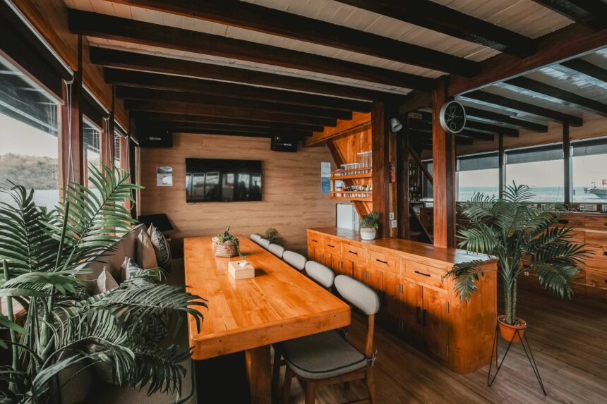 indoor lounge and dining area with a bar and TV aboard the Indo Master liveaboard