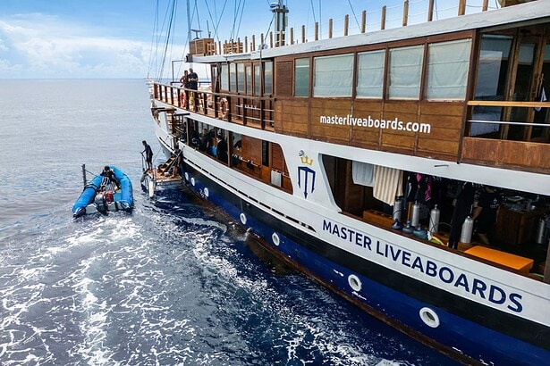 Divers boarding a tender beside the Master Liveaboards Indo Master hull