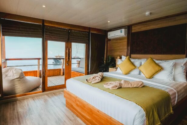 cabin with a double bed and yellow pillows overlooking the water on the Indo Master