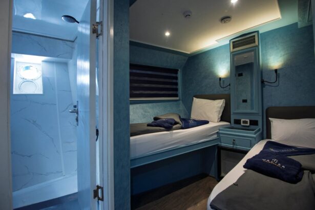 Blue-toned cabin with a single bed and built-in cabinetry along the wall