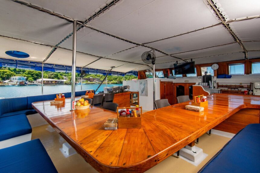 Covered wooden dining deck aboard the Palau Siren overlooking the marina
