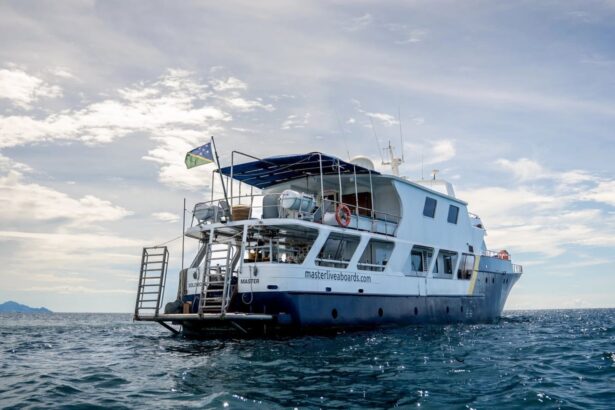 The Solomons Master liveaboard's stern view with its dive deck ladder and Solomon Islands flag