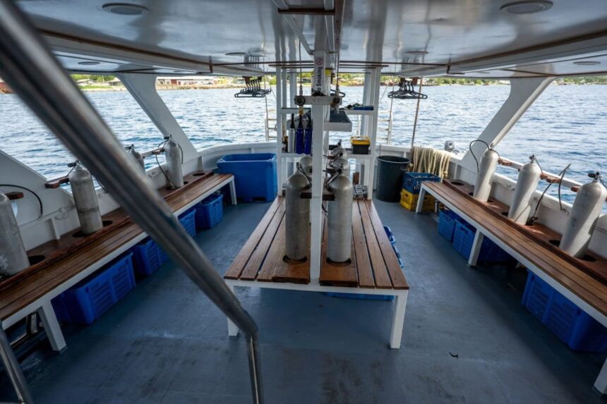 Dive deck aboard the Solomons Master with tanks and gear stations set up between benches