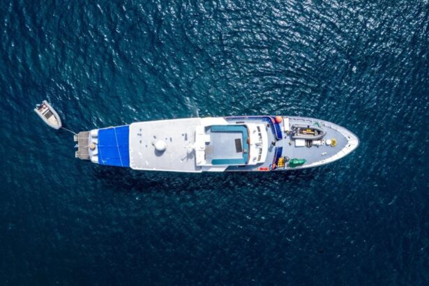 Aerial view of the Solomons Master liveaboard yacht at anchor with a tender boat alongside