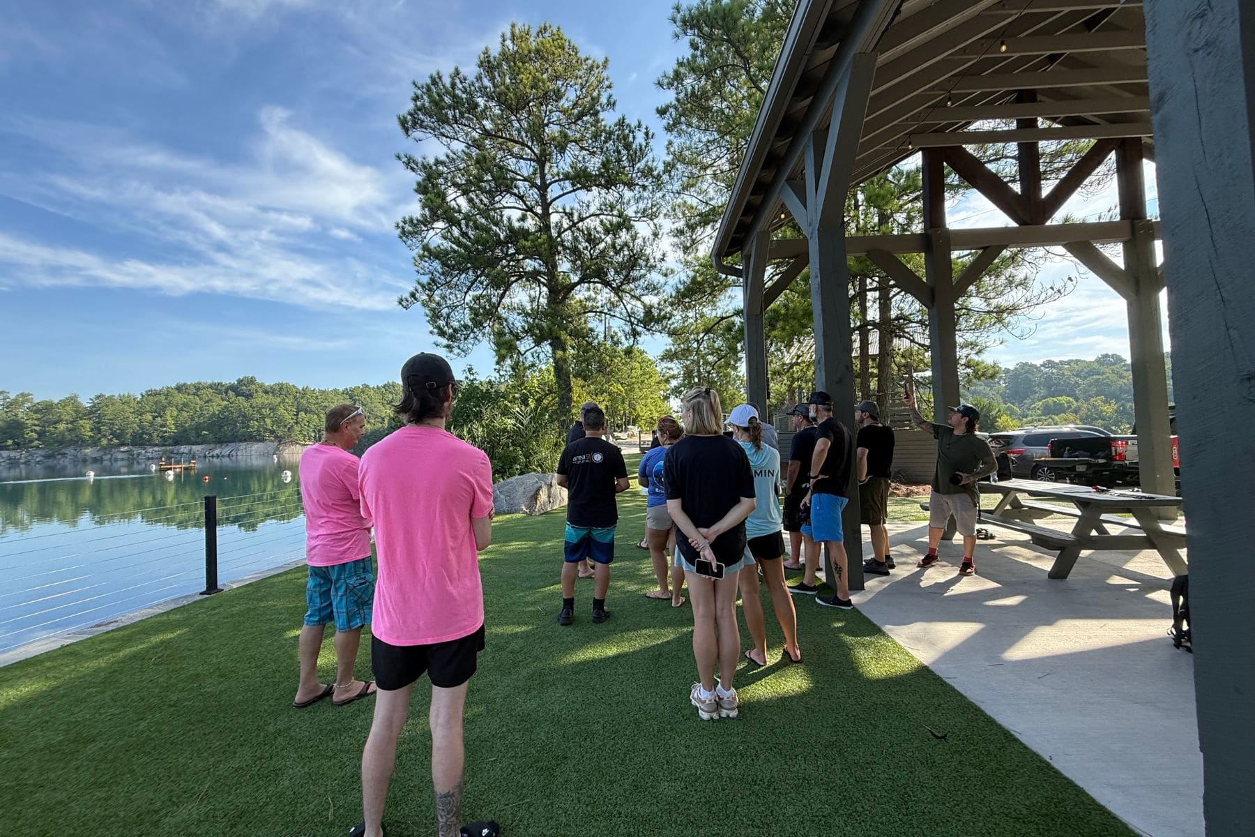 Divers and Garmin staff gather at a lakeside pavilion before testing the Descent S1 Buoy at Fantasy Lake