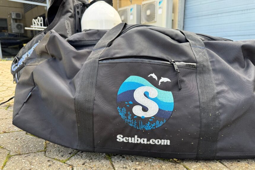 Scuba.com Big Duffel Outdoors Scuba.com Big Duffel Bag lying outdoors next to a Cressi bag and dive gear