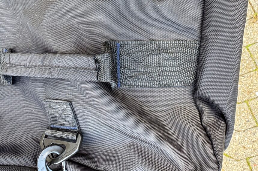 Close-up of the stitched webbing anchoring a carry handle on the Scuba.com Big Duffel