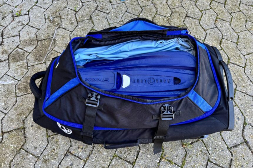 Stahlsac Curacao Clipper duffel opened to show an Aqua Lung Storm BCD and wetsuit packed inside