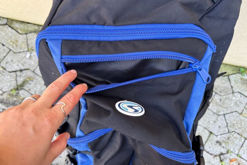 Our tester pointing out the zippered stash pockets on the front of the Stahlsac Curacao Clipper
