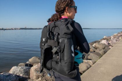 DIVEIN tester seen from behind wearing the Scubapro Hydros Pro BCD on a rocky shoreline