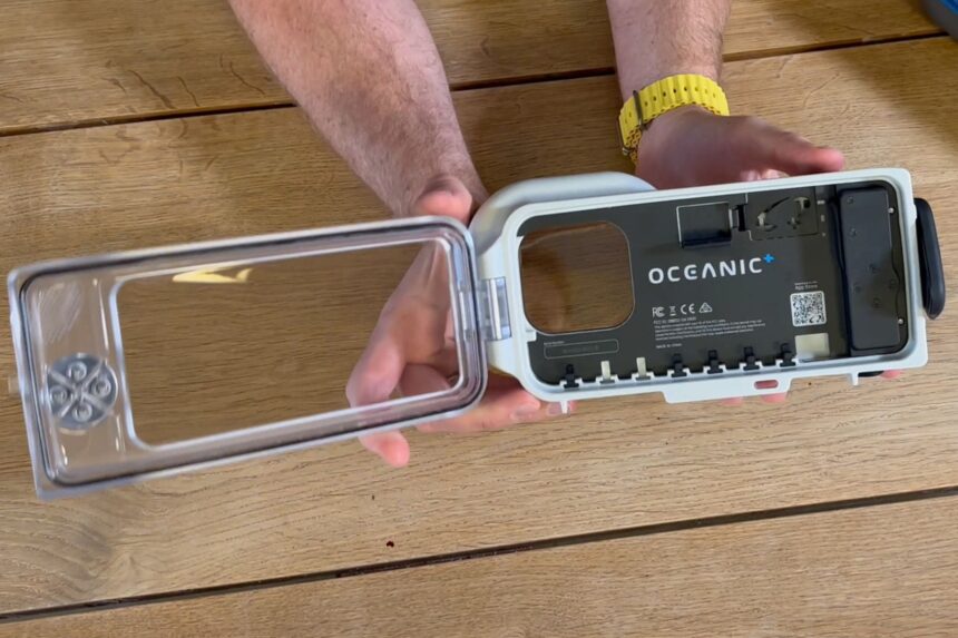 Our reviewer holding the Oceanic+ iPhone housing open, showing the empty phone cradle and back door
