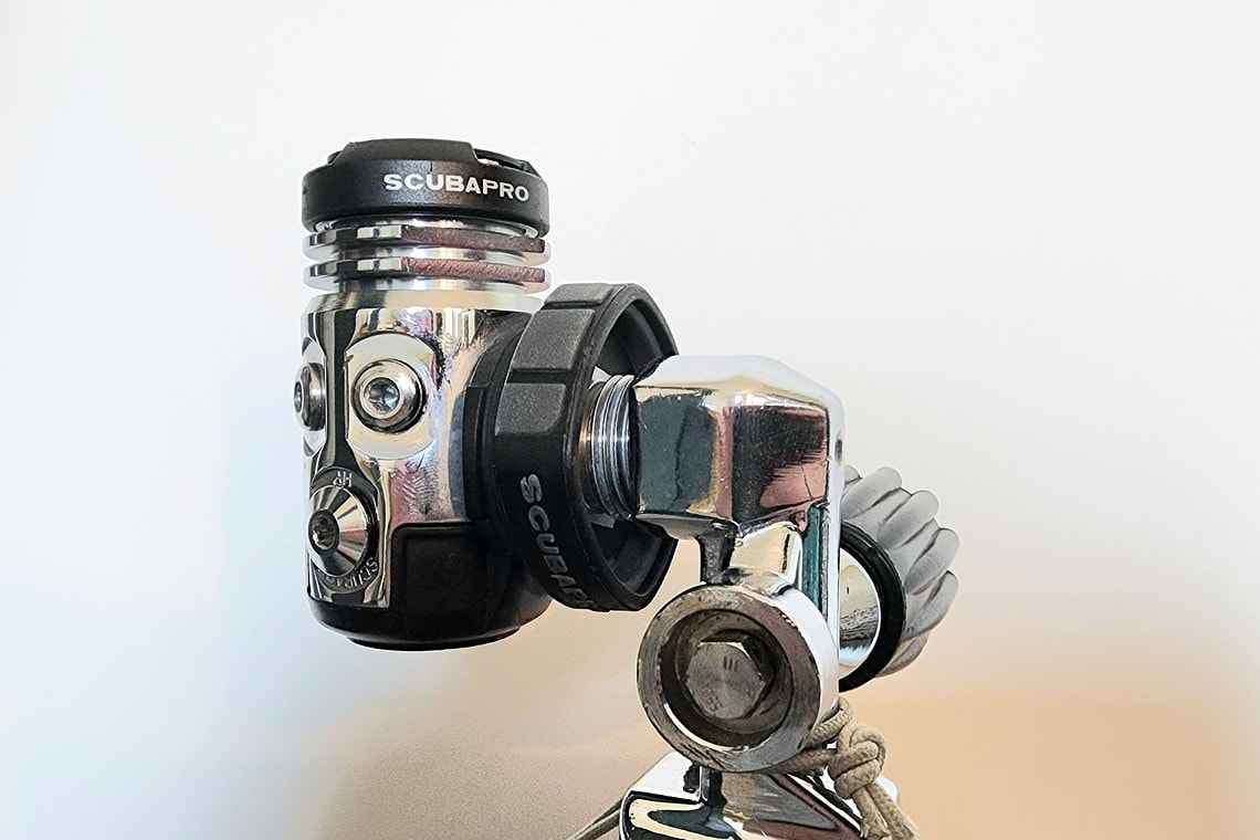 Close-up of the ScubaPro MK17 EVO first stage threaded onto a tank valve during DIVEIN testing
