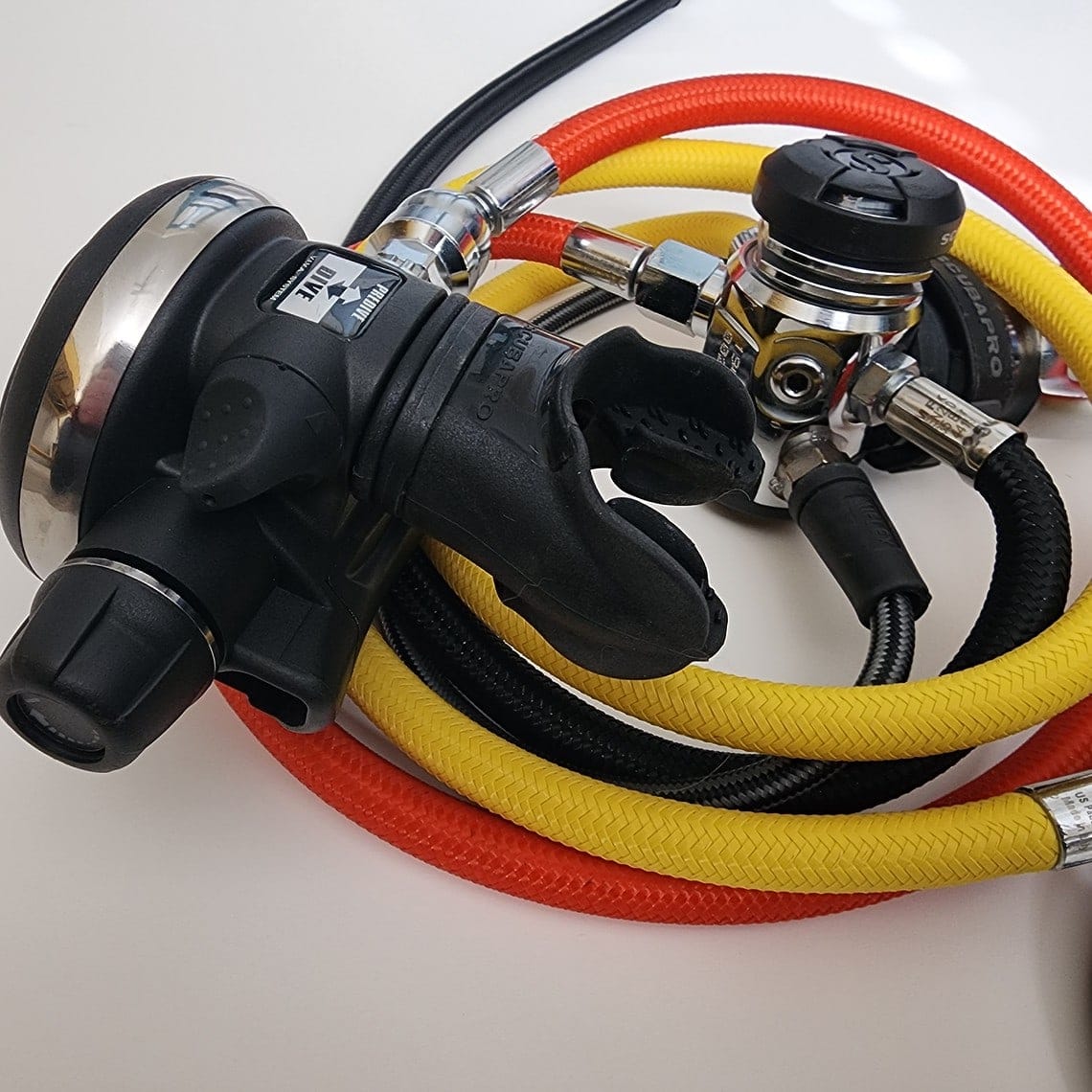 Complete ScubaPro MK17 EVO setup with second stage, octopus and coiled red, yellow and black hoses