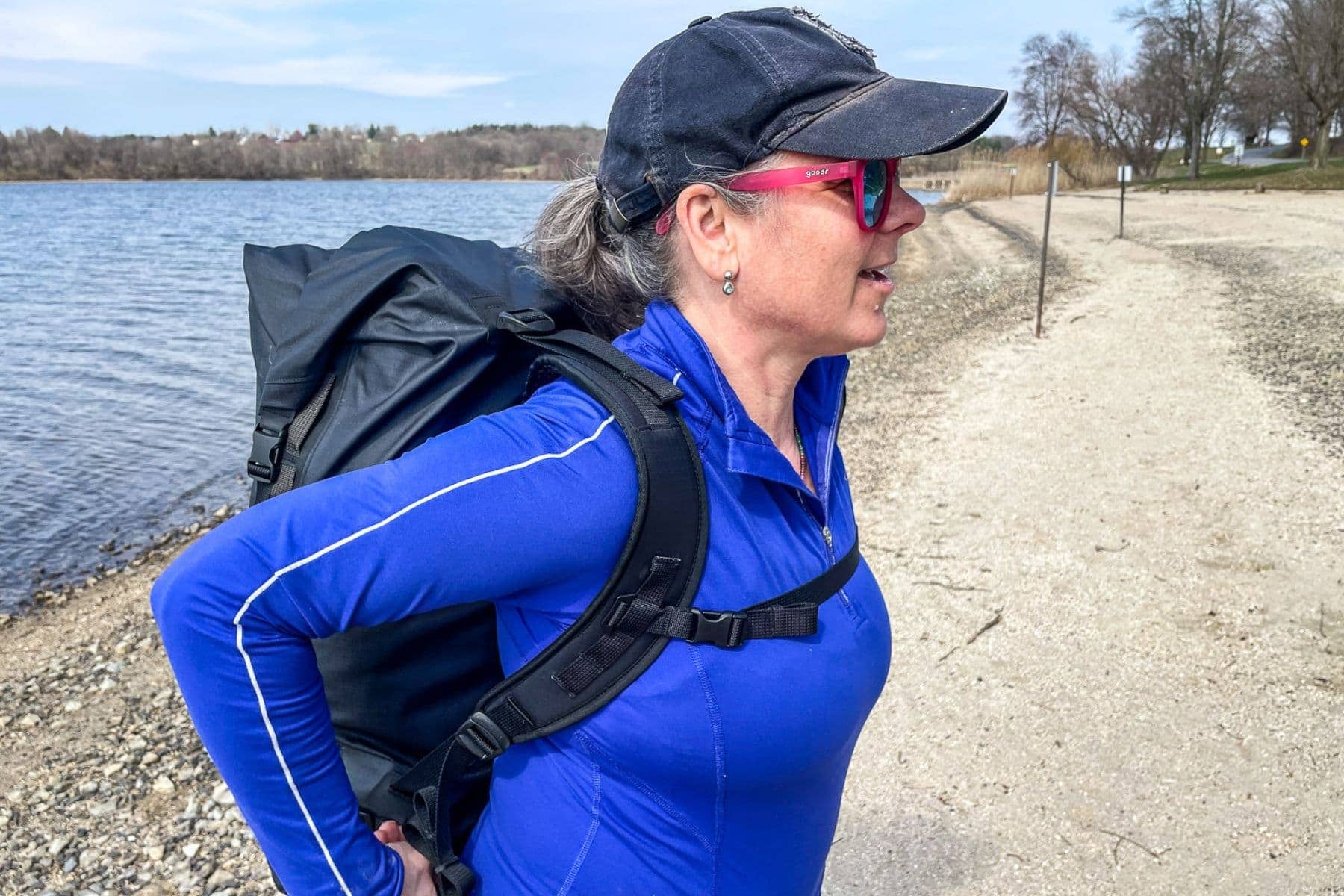 Our tester wearing the Sea to Summit Big River dry pack on a lakeshore path, seen from the side