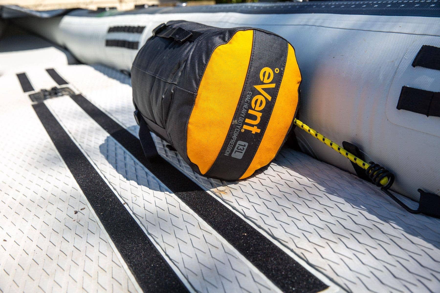 Yellow eVent end panel on the 13L Sea to Summit EVAC Compression HD dry bag resting on an inflatable kayak