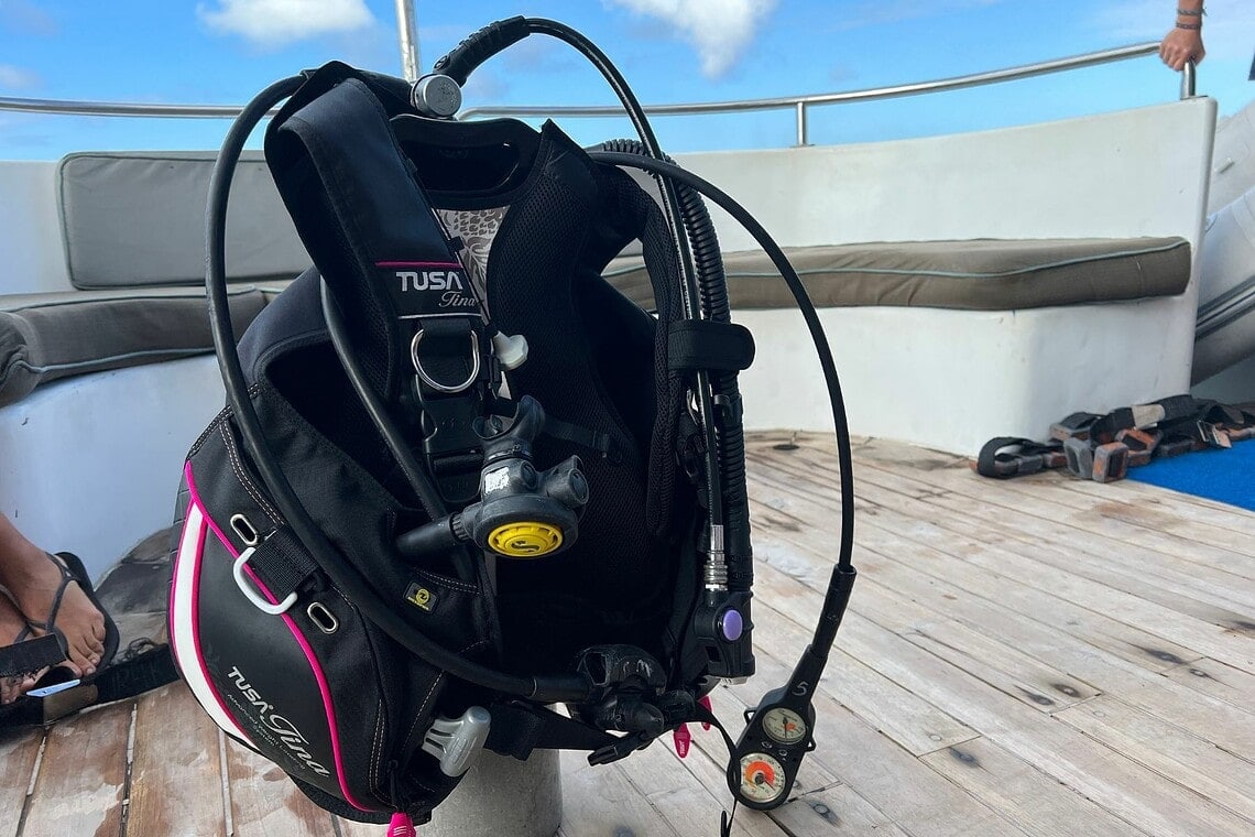 TUSA Tina BCD rigged with regulator, octopus and gauge console on a dive boat deck