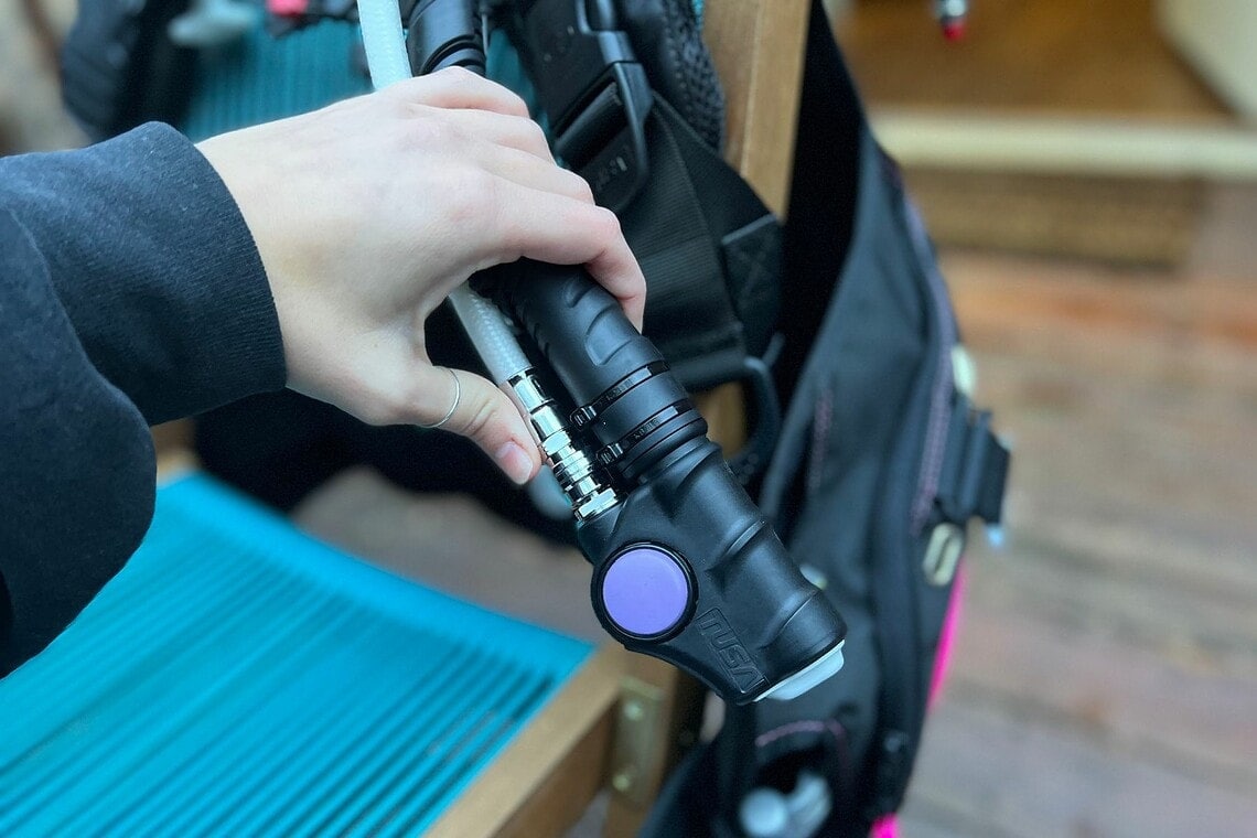 Our tester gripping the TUSA Tina's inflator with its purple deflate button