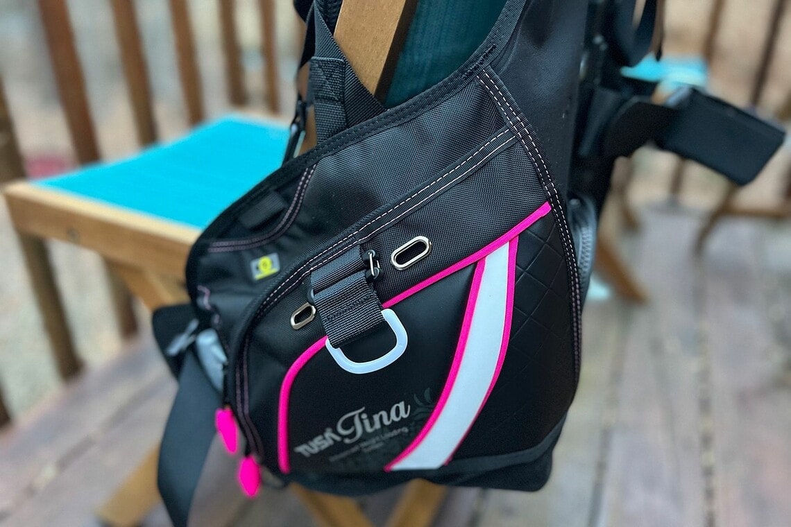 Close-up of the TUSA Tina BCD's large side pocket with pink trim and a metal D-ring