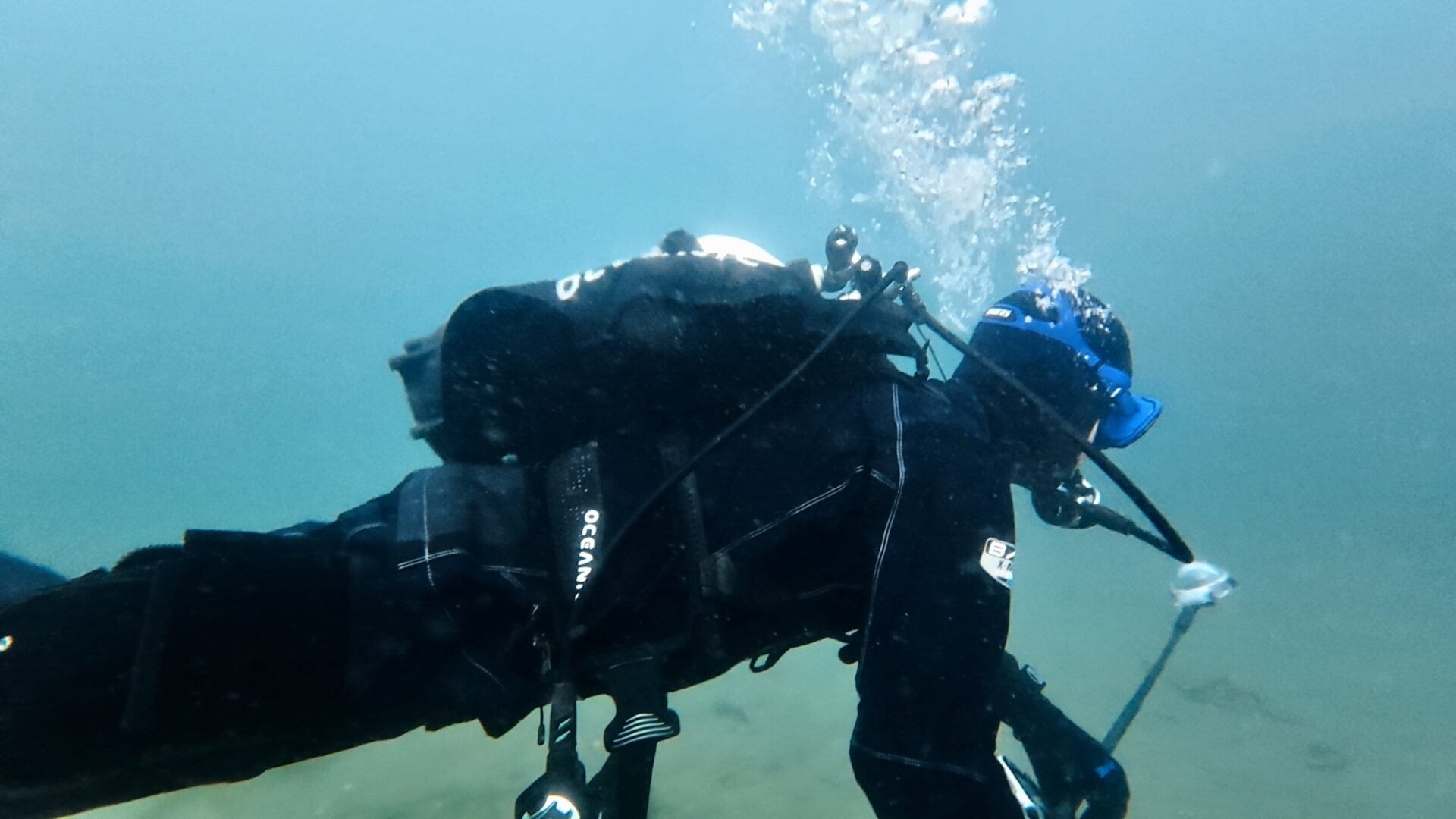 Our tester diving the Oceanic Photon Pro in cold, low-visibility water while wearing a drysuit