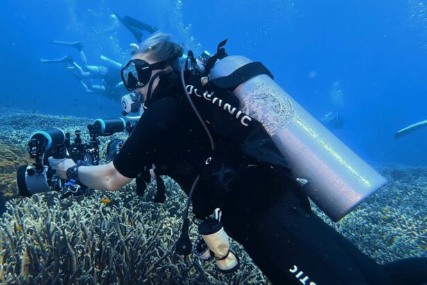 Rear view of our tester in the Oceanic Photon Air BCD carrying a camera rig over a reef