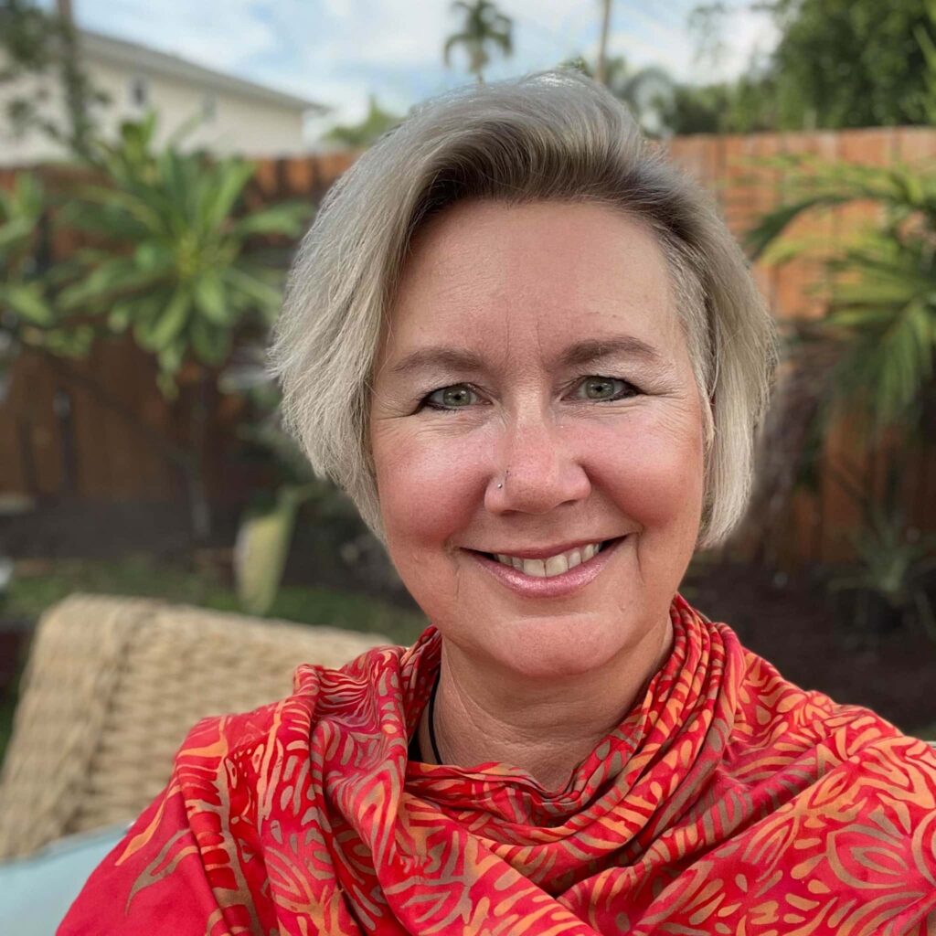 DIVEIN contributor Renee Heil smiling outdoors in her backyard