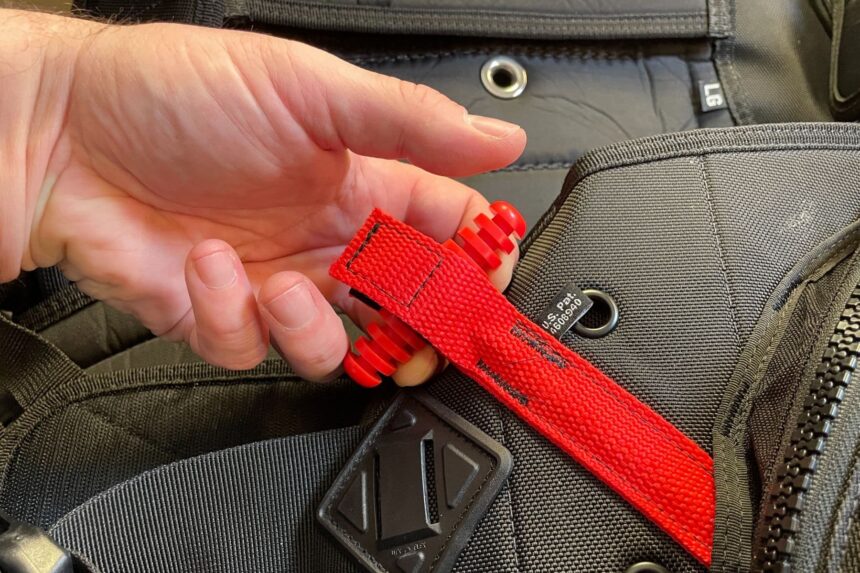 Our tester pulling the red Ripcord release handle on the Zeagle Fury BCD
