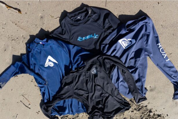 Four long sleeve rash guards from brands including O'Neill and Roxy laid out on sand