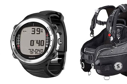 Scuba kit on white: fins, a regulator set, a Suunto dive computer and a black buoyancy jacket