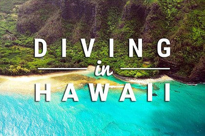 Diving in Hawaii title card over an aerial view of green cliffs, pale sand and a turquoise bay