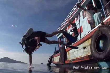 A diver tumbles upside down off a dive boat's swim platform in a botched giant-stride entry