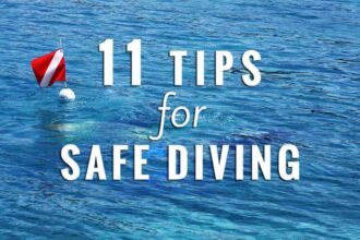 Dive flag buoy floating on blue water with text reading 11 Tips For Safe Diving