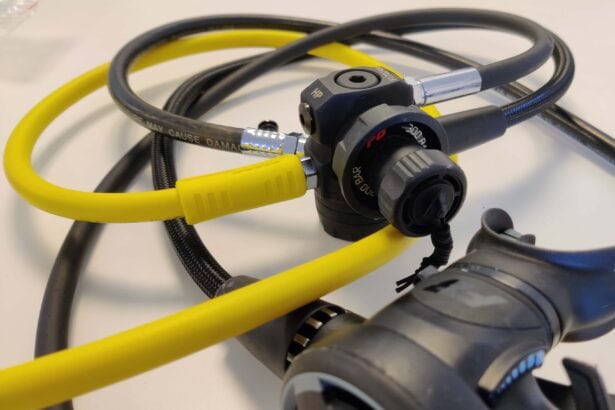 Zeagle F8 first stage with a yellow octopus hose and black hoses coiled on a white surface