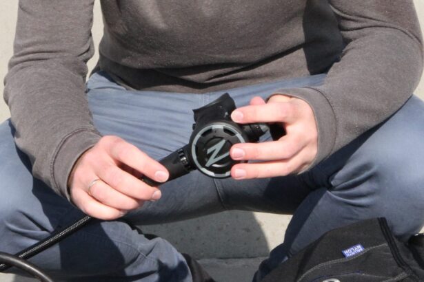 DIVEIN tester inspecting the Zeagle F8 second stage regulator in hand before a shore dive
