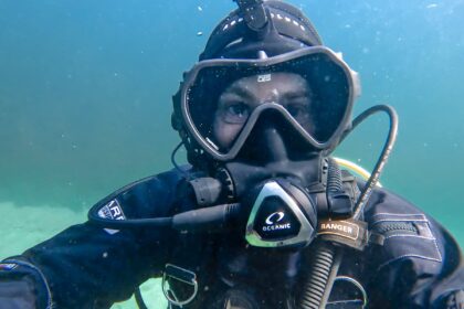 Our tester swimming underwater in the OTS Spectrum full face mask with the regulator mounted at the front