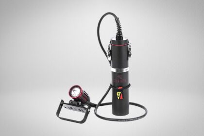 Dive Rite EX35 canister dive light with a red and black light head on a handle mount, corded to a battery canister