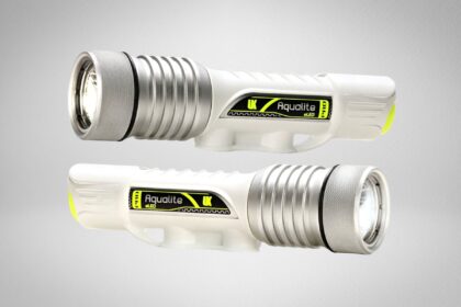 Underwater Kinetics Aqualite dive light shown from both sides, white body with yellow accent and moulded handle