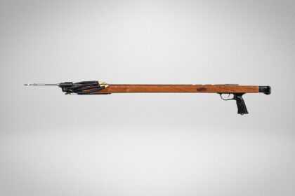 JBL American Made mahogany speargun in profile with black rubber bands and loaded spear