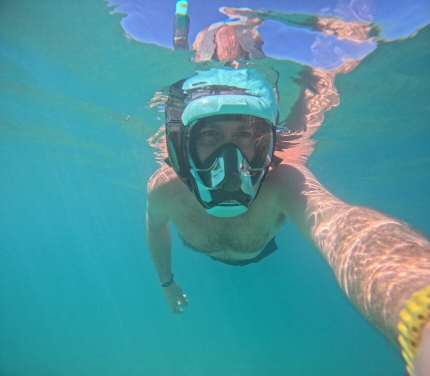 Seaview 180 V3 Full Face Mask In Use DIVEIN tester wearing the Seaview 180 V3 full face snorkel mask while swimming in clear turquoise water