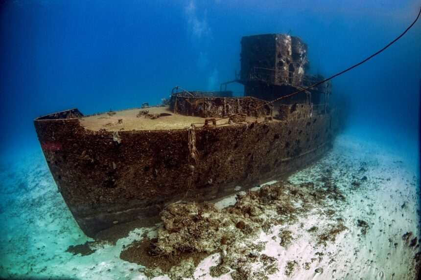 Shallow Shipwreck Off Cozumel Sunken vessel sitting upright on white sand at a shallow Cozumel wreck site