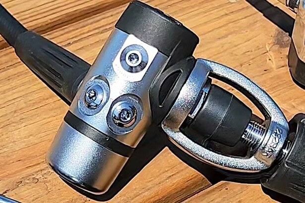 Top view of the Brut Pro first stage on a wooden deck showing its port layout