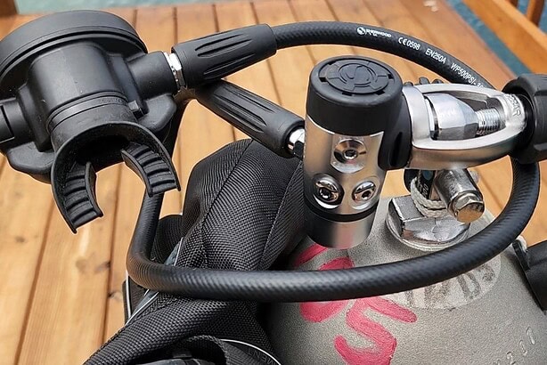 Sherwood Brut Pro fitted to a tank valve on a rigged BCD on a wooden dock