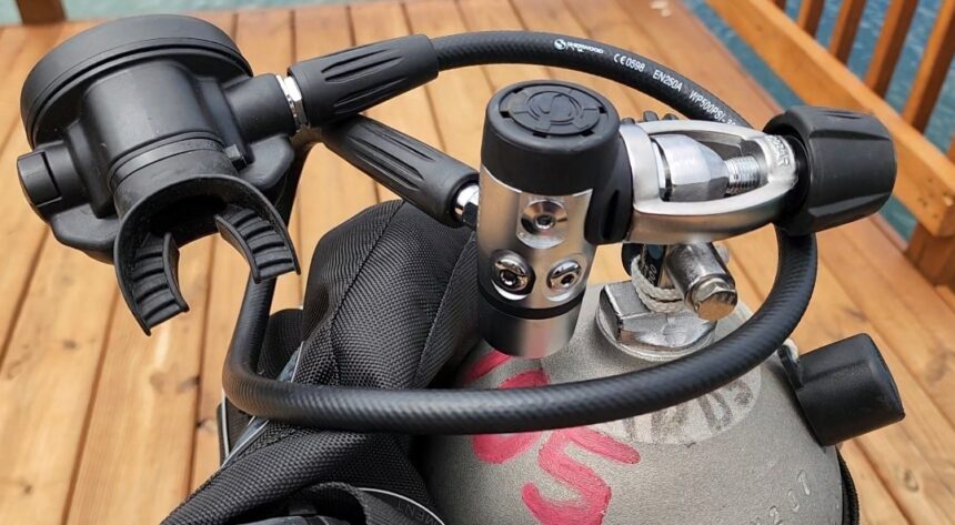 Sherwood Brut Pro fitted to a tank valve on a rigged BCD on a wooden dock