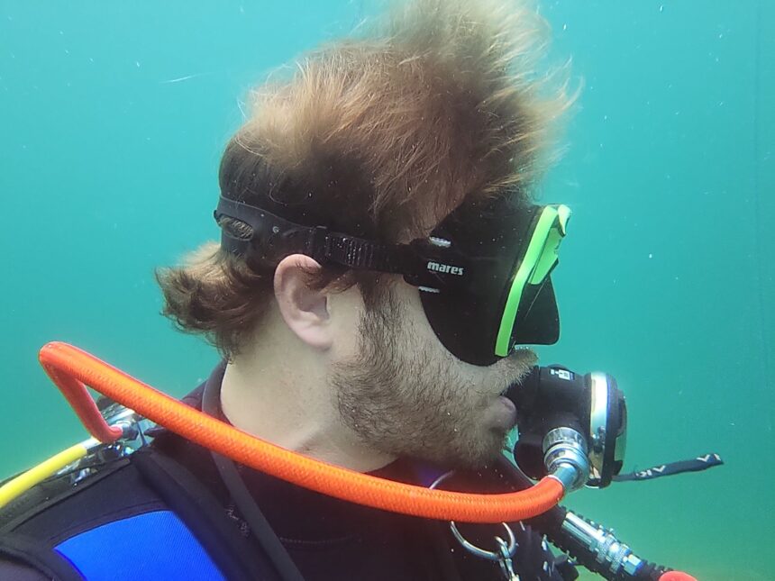 Our tester in profile underwater with the Mares X-Vision strap sitting above his ear