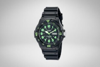 Casio MRW200H analog watch with black resin strap and green numerals on a plain grey background